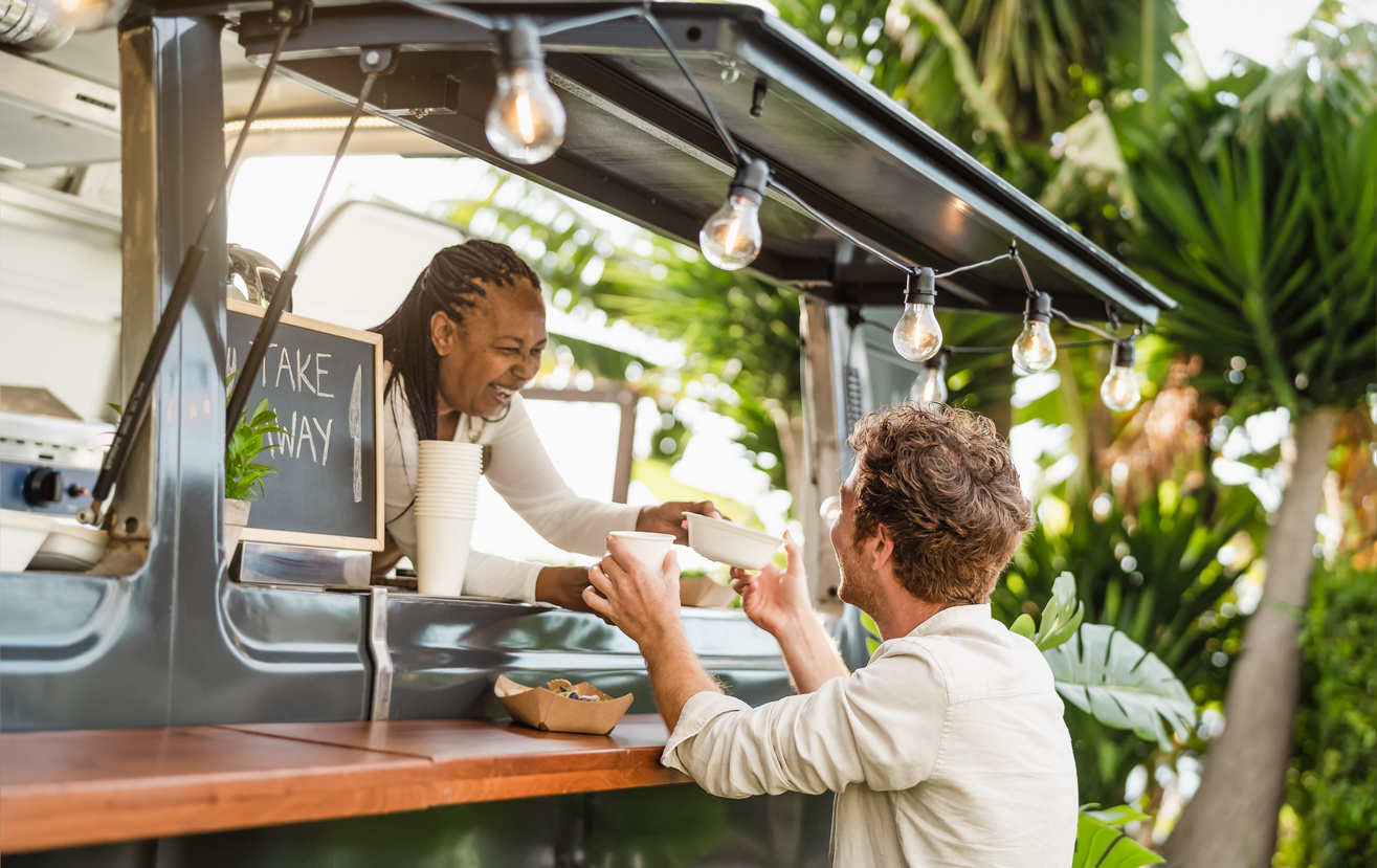 Woman Serving Food in Food Truck